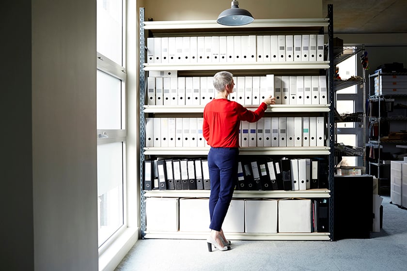 Woman in an office looking at folders