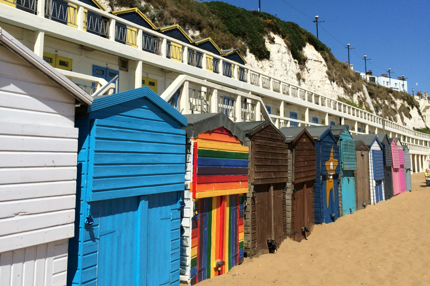 row or colorrul houses by the waves at the beach. 