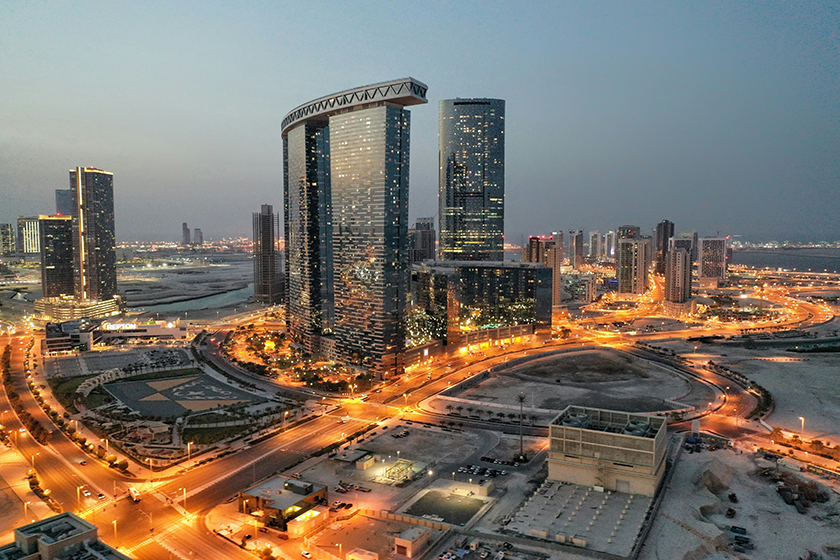 Al Reem Island - Abu Dhabi - United Arab Emirates at night, with lights in the buildings and on the roads.
